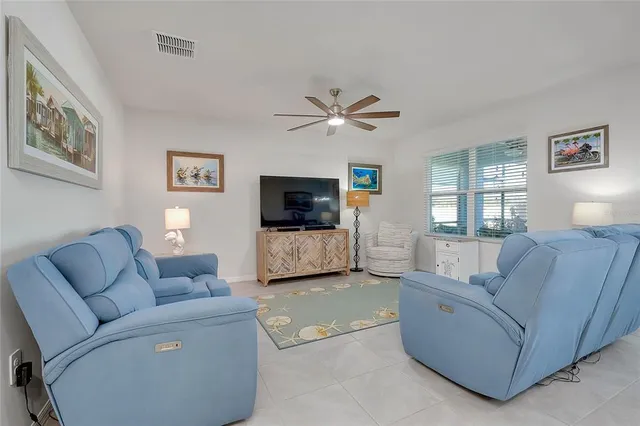 a living room with furniture and a view of kitchen