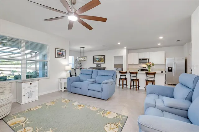 a kitchen with a refrigerator and a dining table