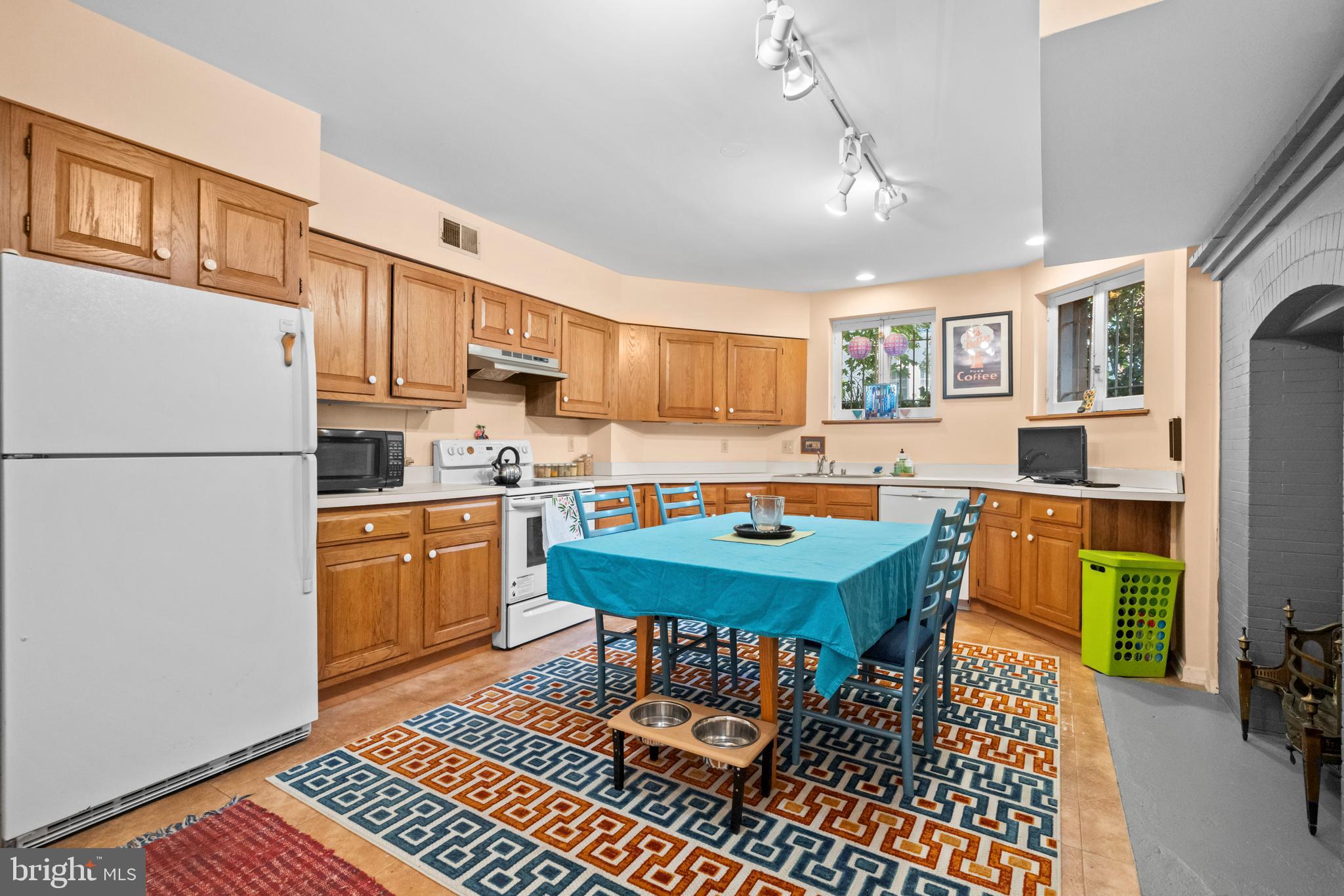 2516 Cliffbourne Place Northwest Washington, DC 20009 - Photo 12 of 34 a kitchen with stainless steel appliances granite countertop a refrigerator a stove a sink dishwasher a dining table and chairs with wooden floor