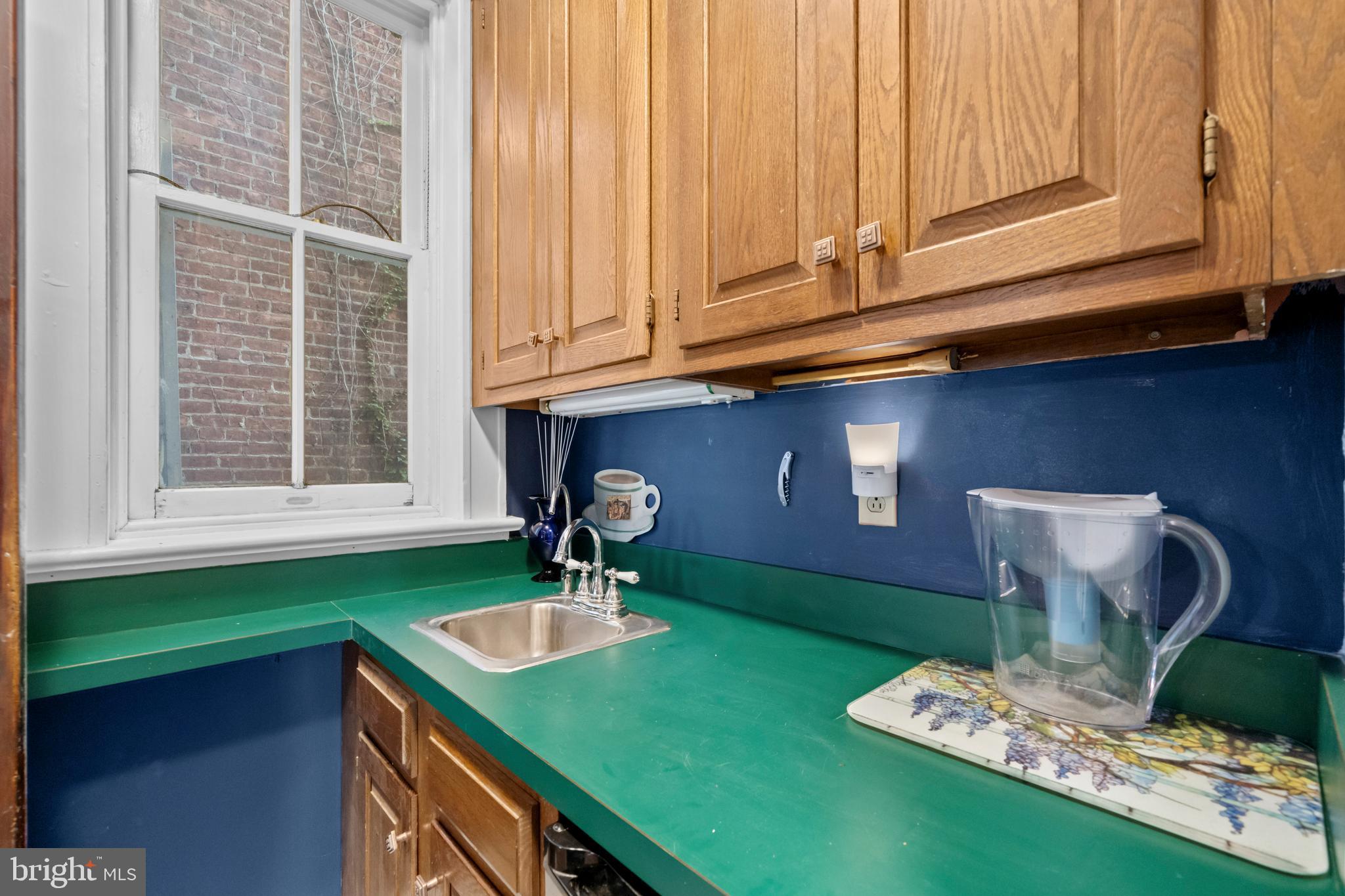 2516 Cliffbourne Place Northwest Washington, DC 20009 - Photo 10 of 34 a kitchen with a sink cabinets and a wooden floor