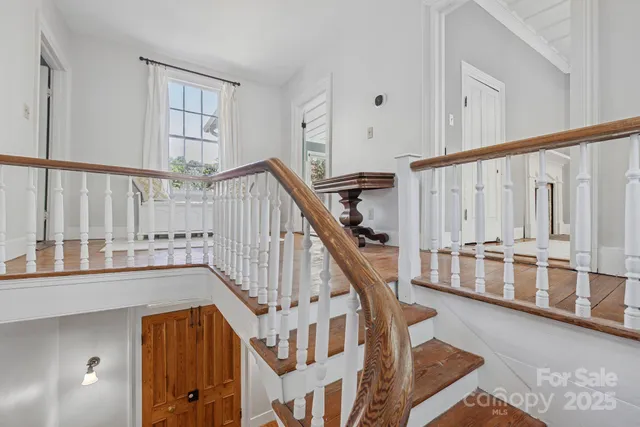 a view of a house with a backyard and a large tree