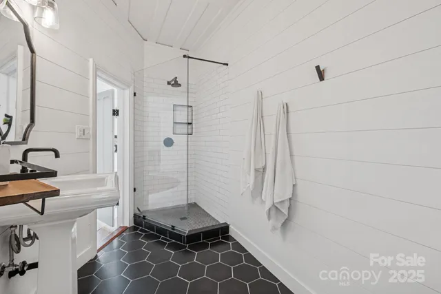 a view of a garden with lawn chairs under an umbrella