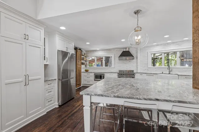 a living room with furniture a fireplace and wooden floor