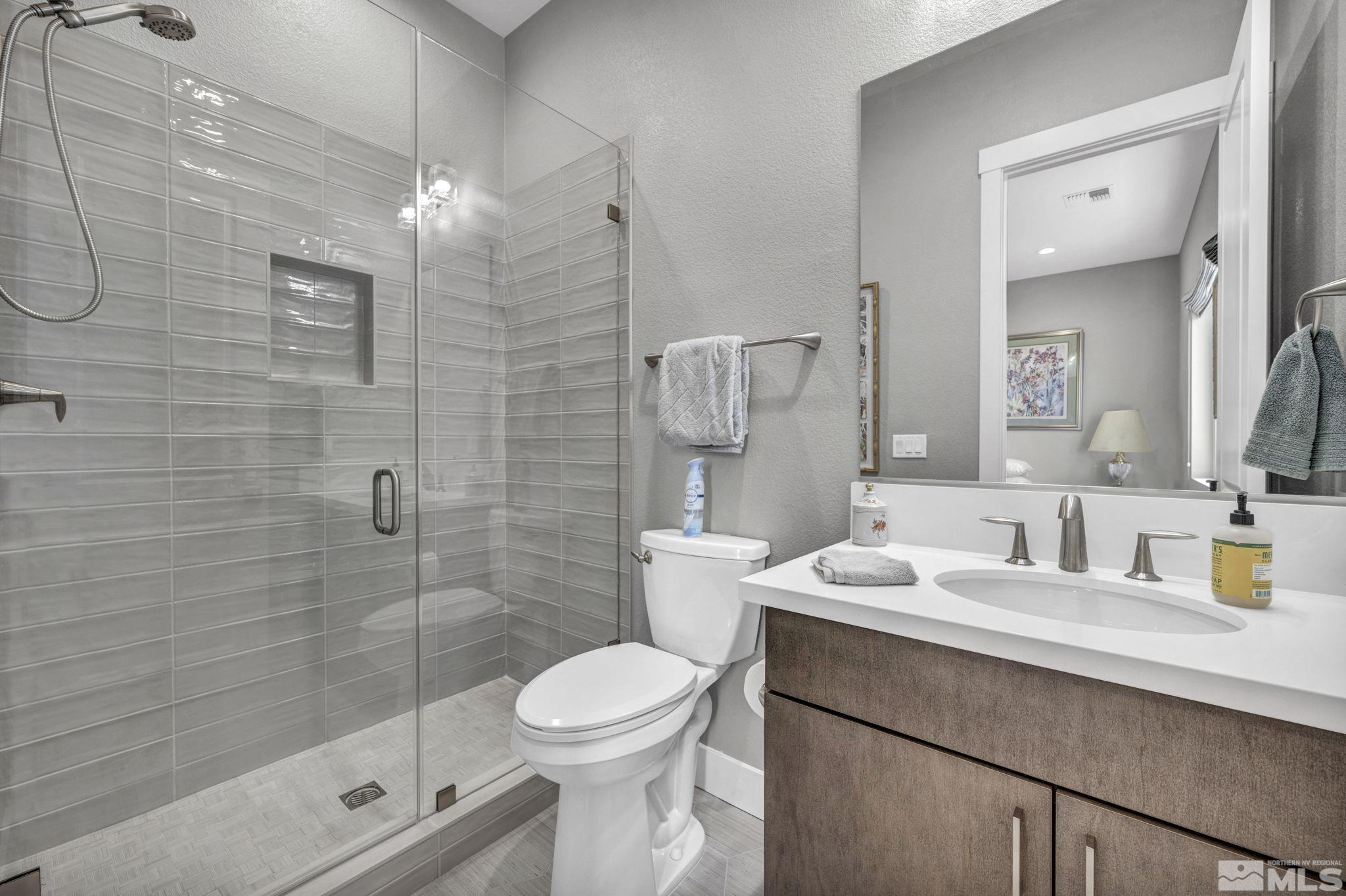 14028 Prairie Land Way Reno, NV 89521 - Photo 32 of 39 a bathroom with a sink a toilet and shower