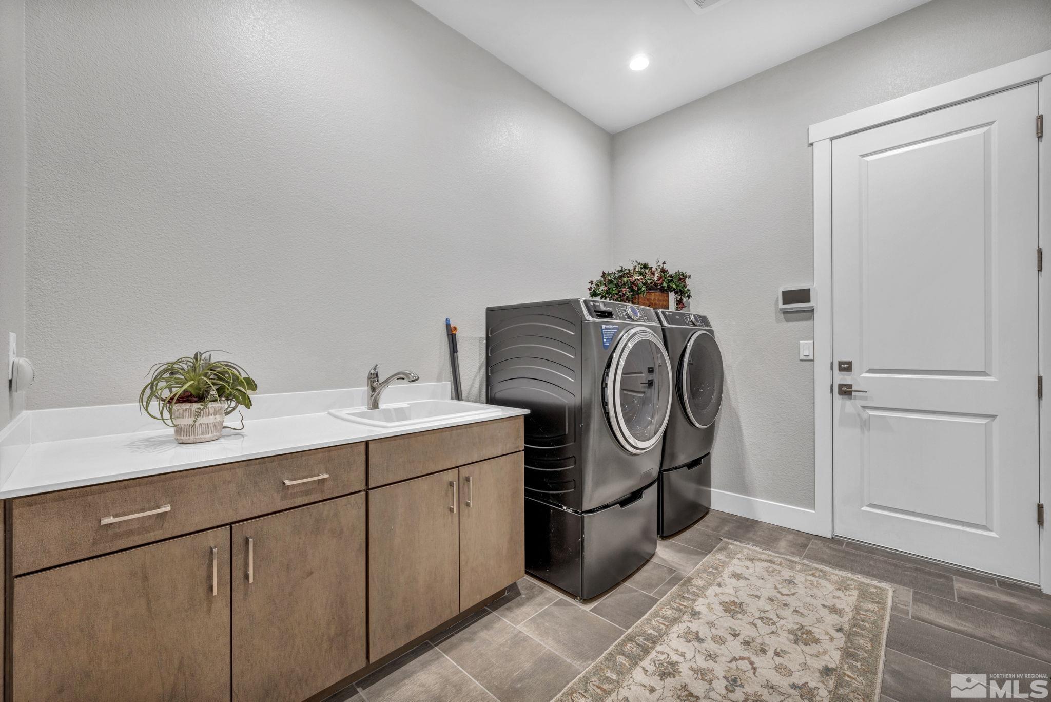 14028 Prairie Land Way Reno, NV 89521 - Photo 34 of 39 a utility room with sink dryer and washer