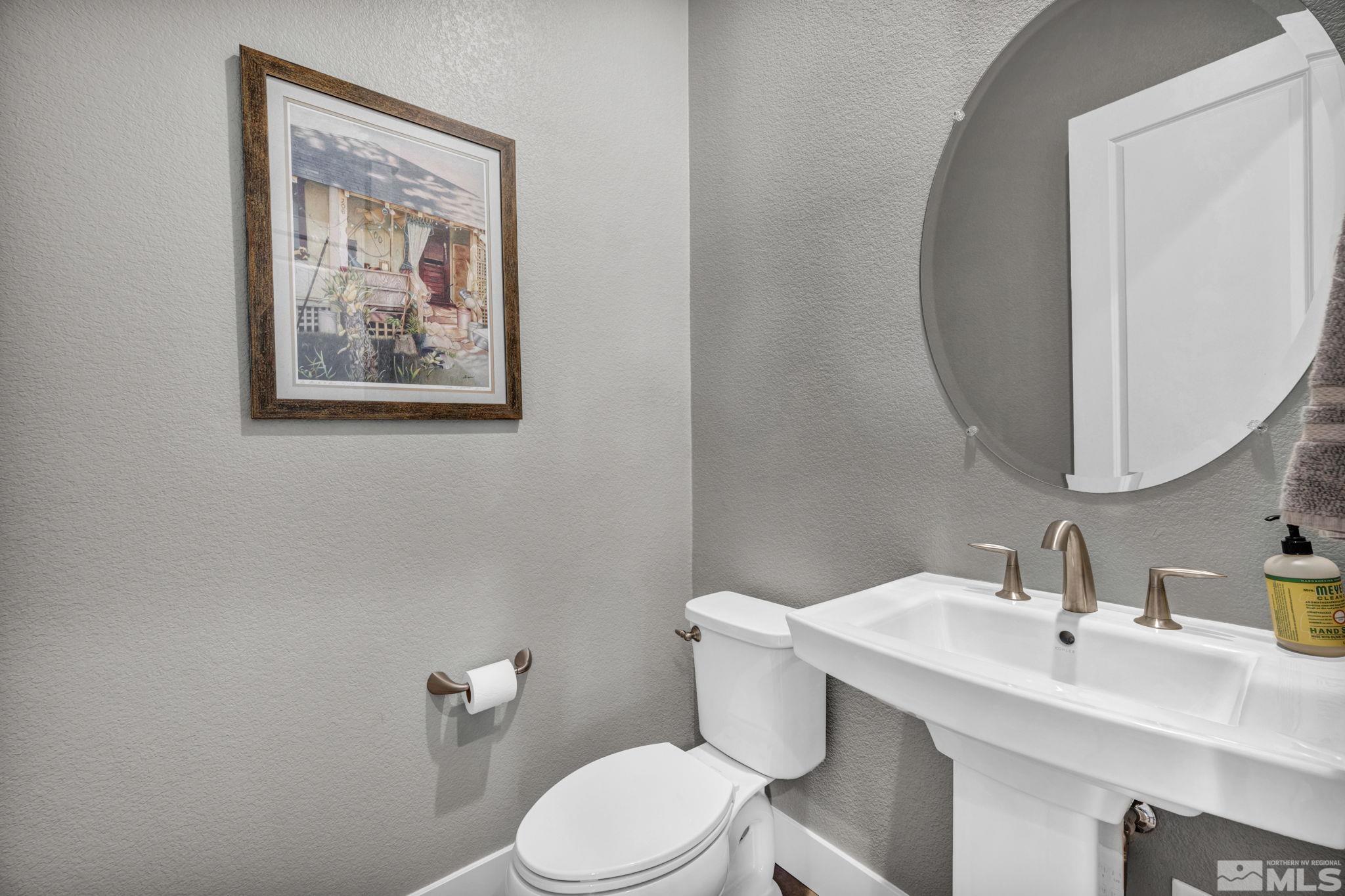 14028 Prairie Land Way Reno, NV 89521 - Photo 35 of 39 a bathroom with a toilet a sink and mirror