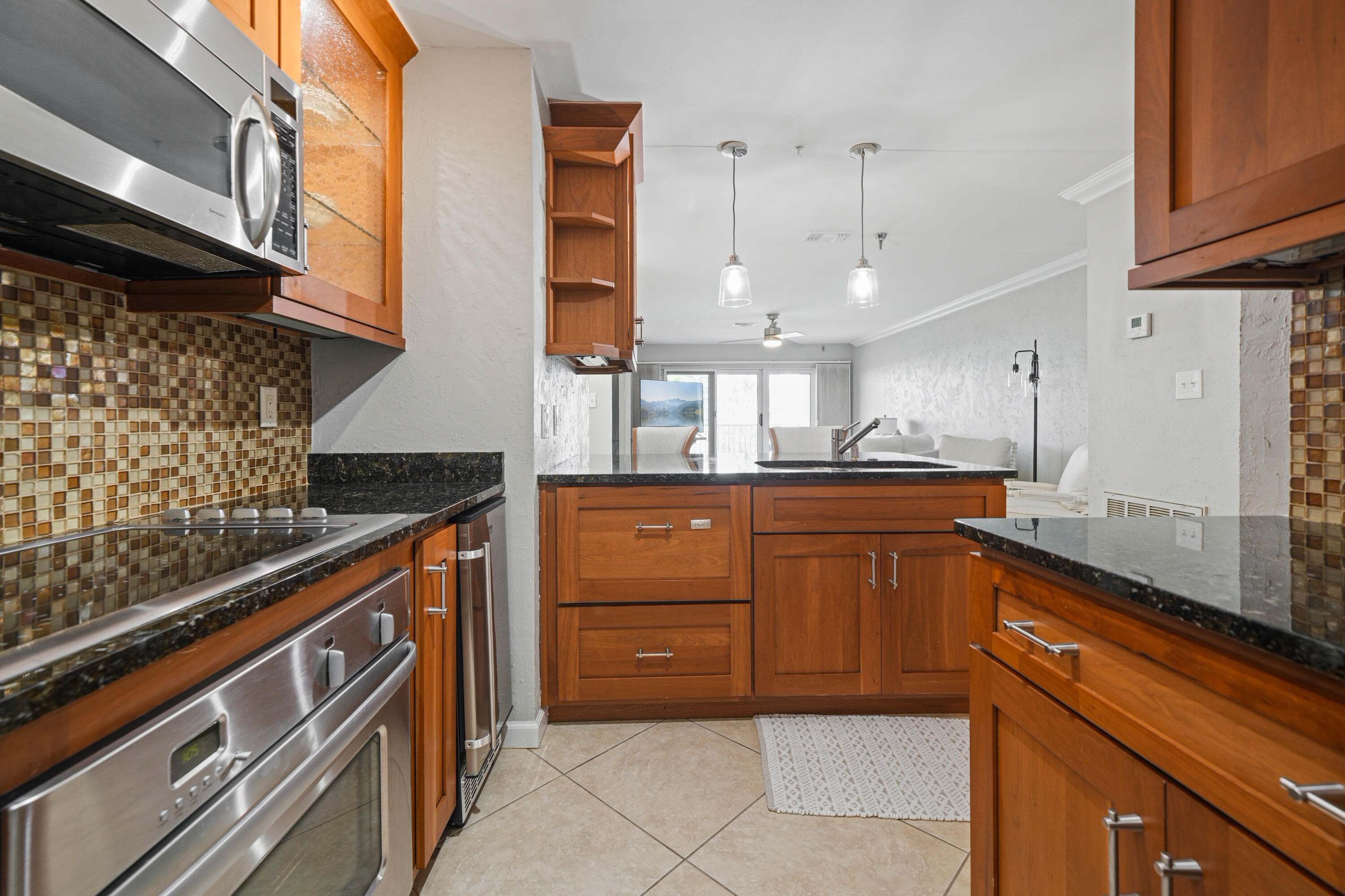 197 Durango Road, Unit 3D Destin, FL 32541 - Photo 13 of 43 a kitchen with stainless steel appliances granite countertop a sink and cabinets