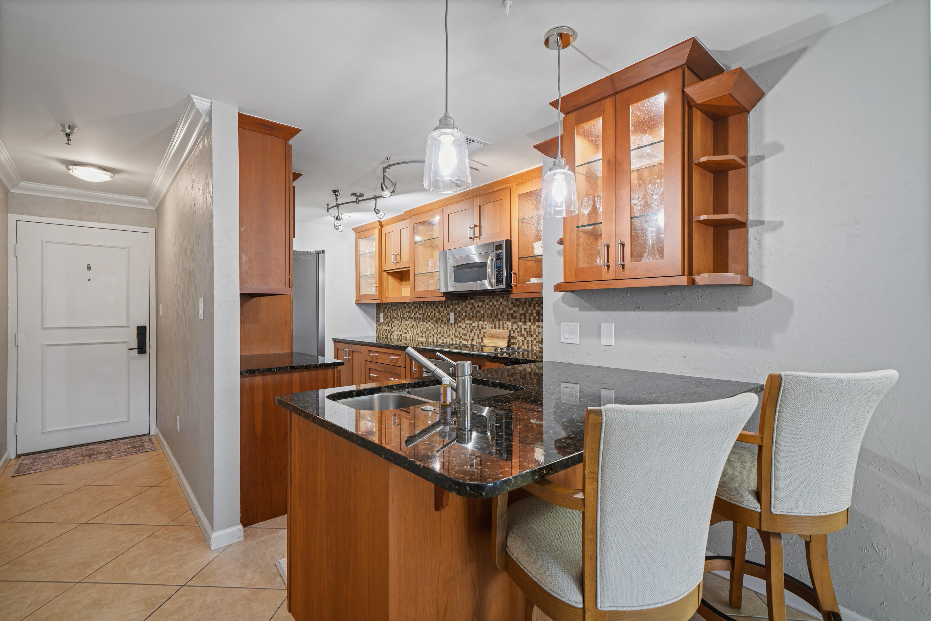 197 Durango Road, Unit 3D Destin, FL 32541 - Photo 14 of 43 a kitchen that has a microwave a sink and a stove