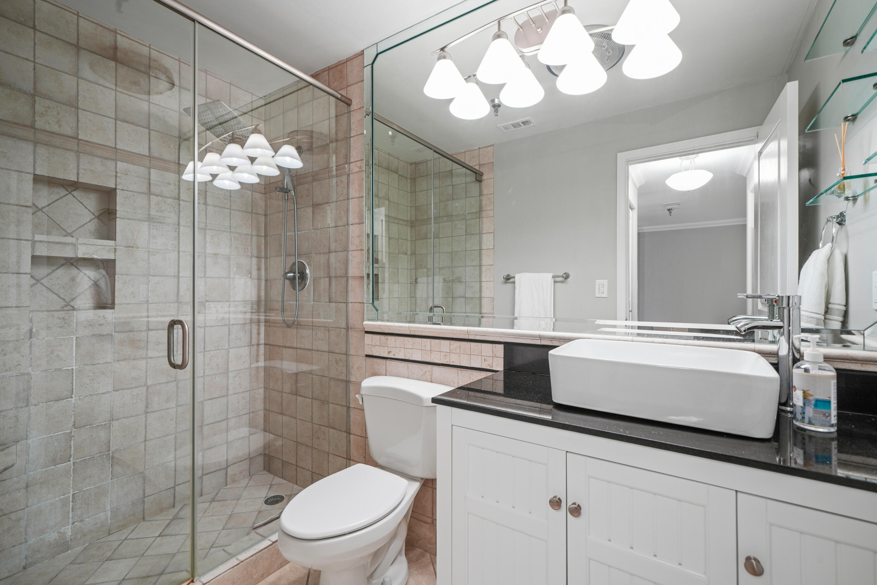 197 Durango Road, Unit 3D Destin, FL 32541 - Photo 17 of 43 a bathroom with a sink a toilet and a mirror