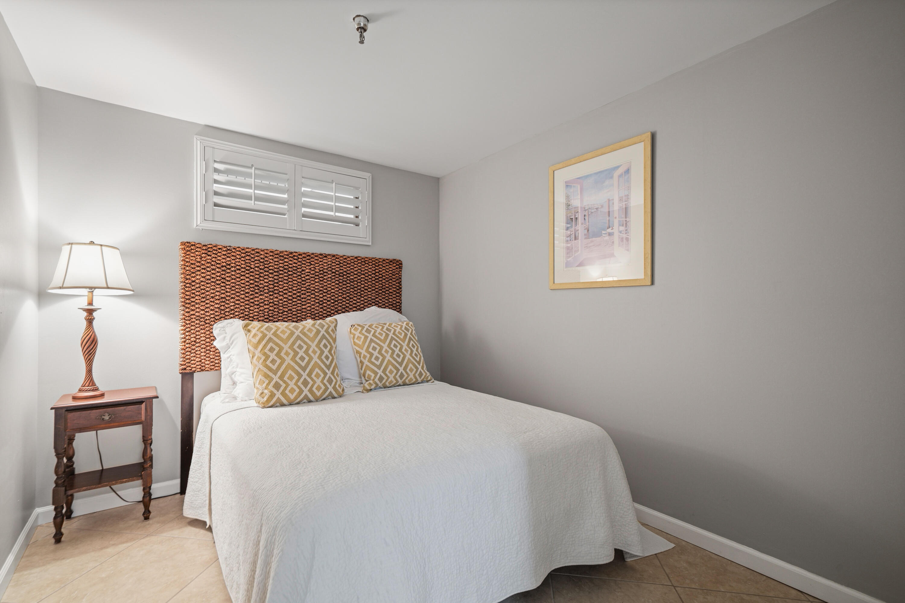 197 Durango Road, Unit 3D Destin, FL 32541 - Photo 19 of 43 a bedroom with a bed and a lamp