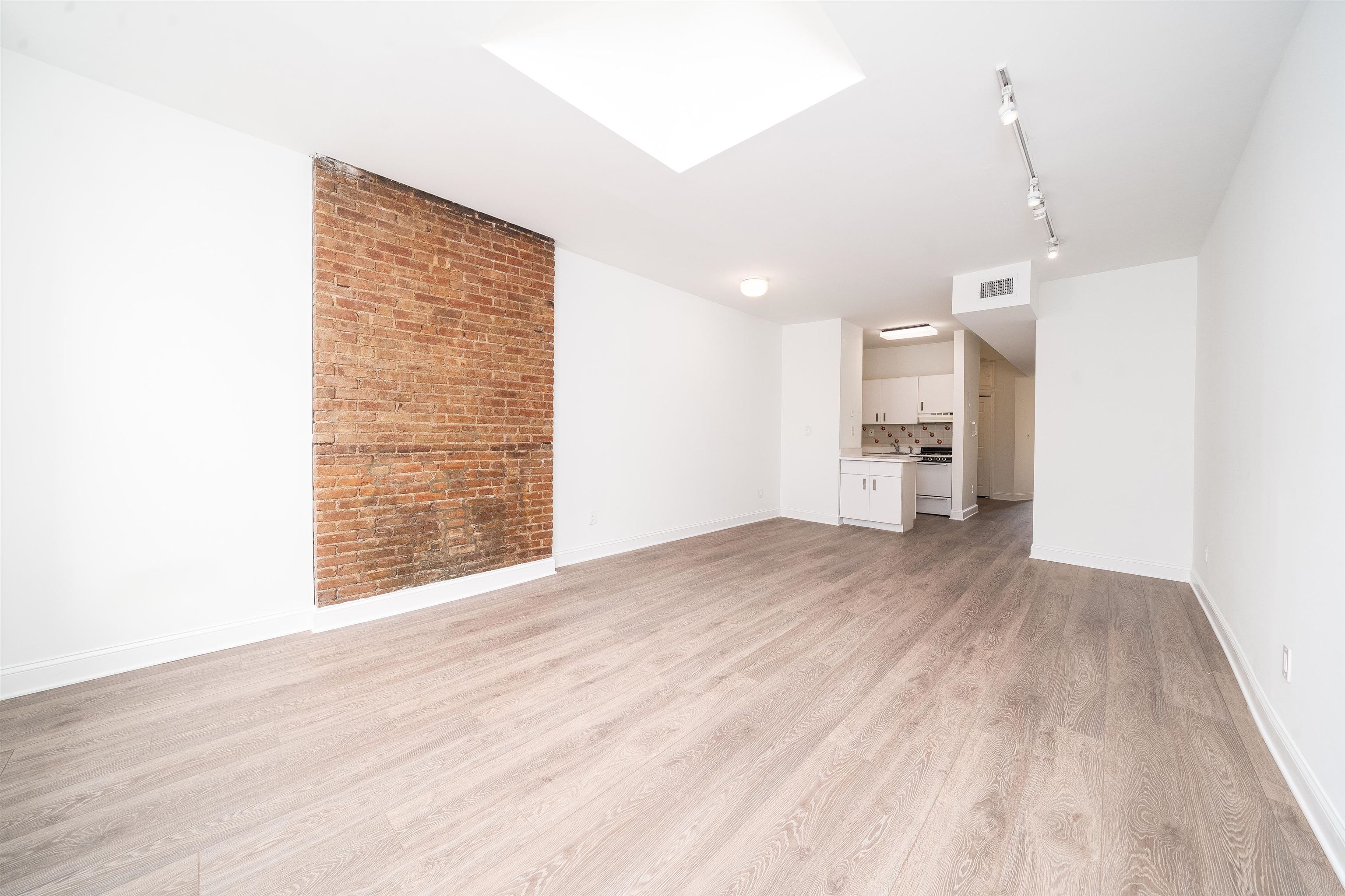 157 14th Street, Unit 5L Hoboken, NJ 07030 - Photo 3 of 11 a view of empty room with wooden floor and fan
