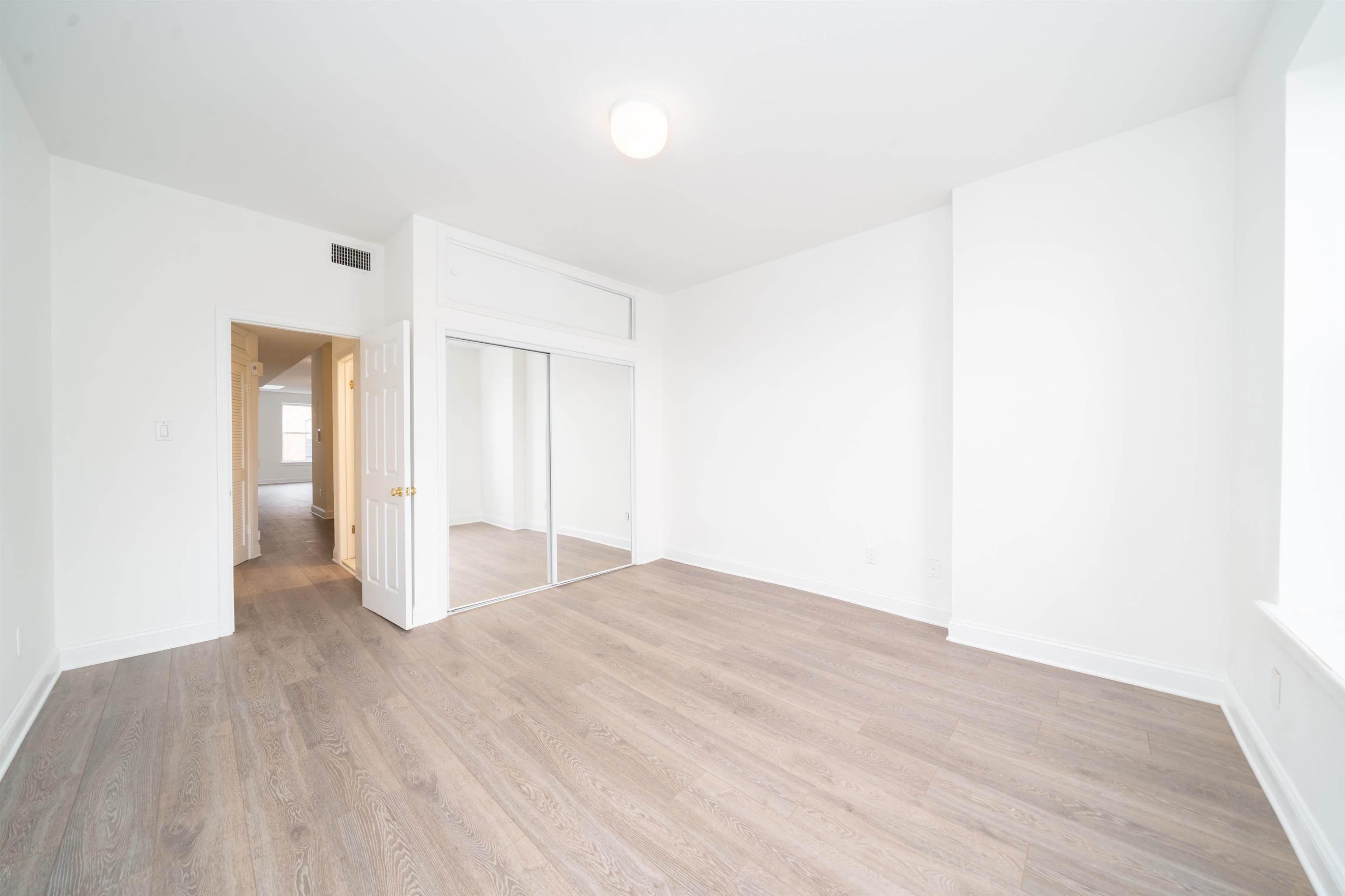 157 14th Street, Unit 5L Hoboken, NJ 07030 - Photo 8 of 11 a view of an empty room with wooden floor