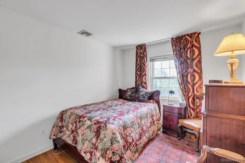 a bedroom with a bed and a lamp