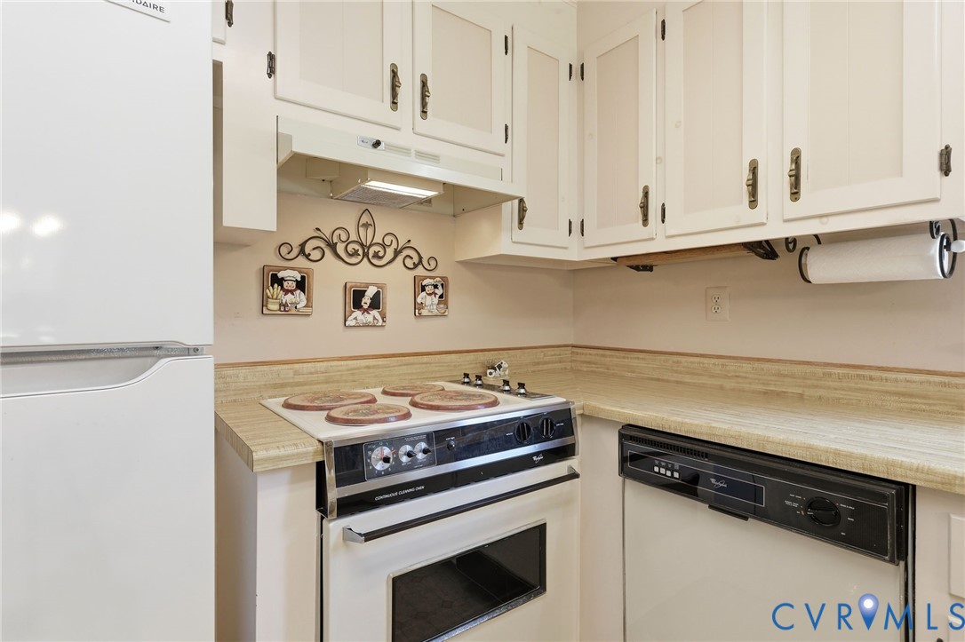 10111 Tunstall Road New Kent, VA 23124 - Photo 16 of 52 Kitchen featuring white upper cabinetry, light-ton