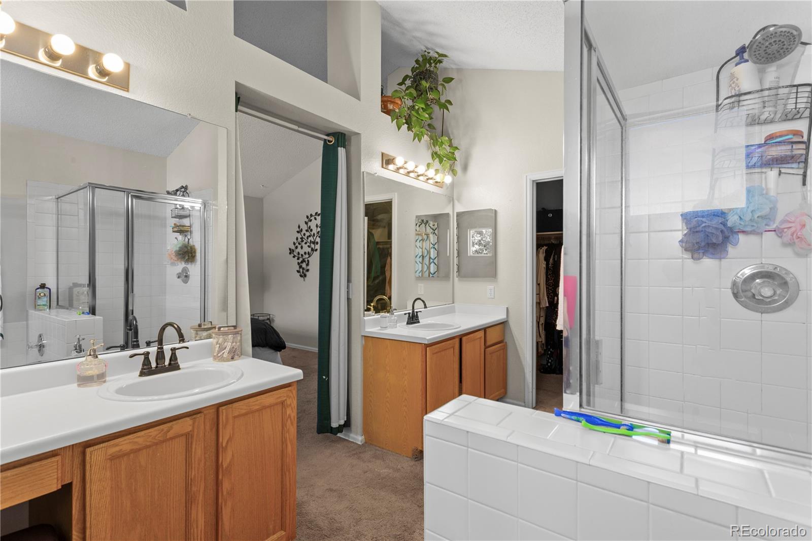 2212 Hyacinth Road Littleton, CO 80129 - Photo 23 of 44 a bathroom with a sink double vanity and a mirror