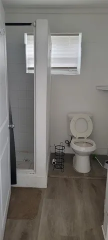 a bathroom with a toilet and a shower