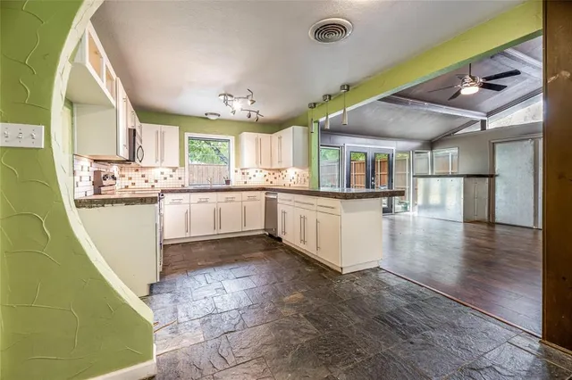 a kitchen with stainless steel appliances granite countertop a sink and cabinets
