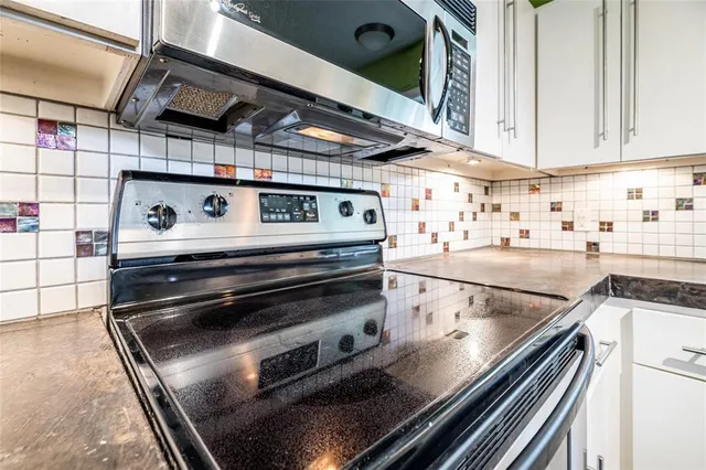 a stove top oven sitting inside of a kitchen