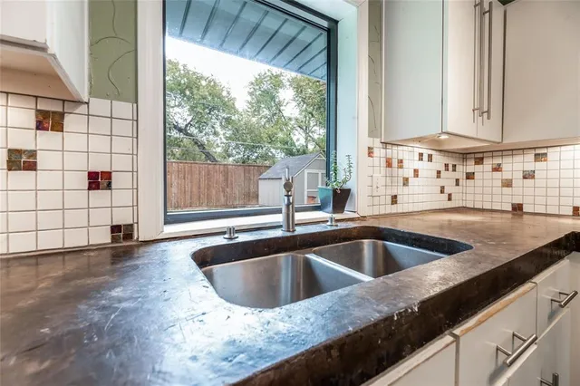 a kitchen with a sink and a window