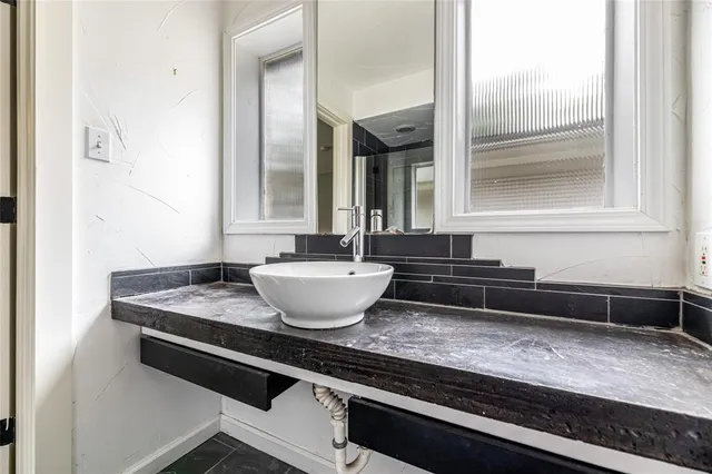 a living room with granite countertop a sink and a granite counter top