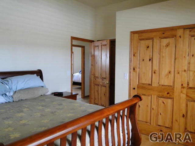 2501 Riata Ranch Road Grand Junction, CO 81505 - Photo 11 of 16 a bedroom with a bed and a dresser