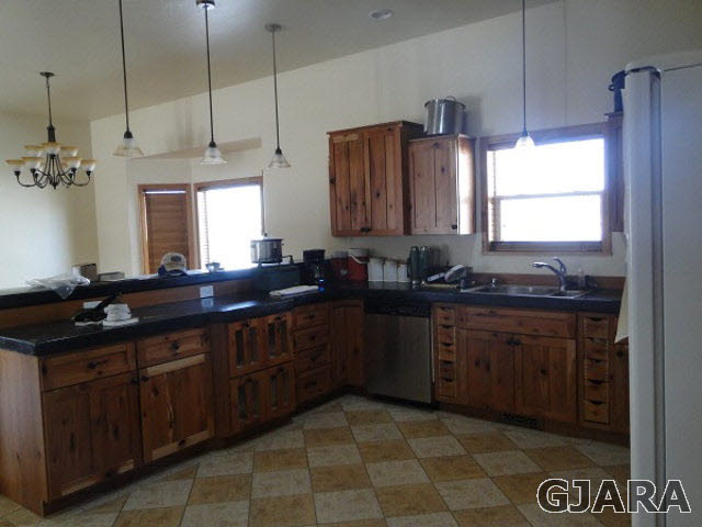 2501 Riata Ranch Road Grand Junction, CO 81505 - Photo 5 of 16 a kitchen with a sink stove and cabinets