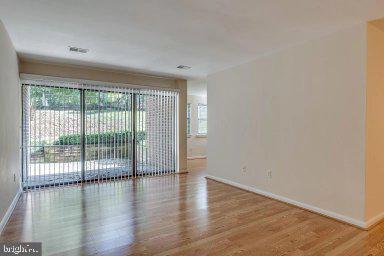 11232 Chestnut Grove Square, Unit 20 Reston, VA 20190 - Photo 12 of 40 wooden floor in an empty room with a window
