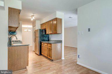 11232 Chestnut Grove Square, Unit 20 Reston, VA 20190 - Photo 17 of 40 a view of kitchen with granite countertop cabinets and refrigerator