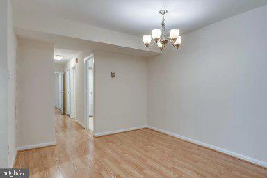 11232 Chestnut Grove Square, Unit 20 Reston, VA 20190 - Photo 19 of 40 wooden floor in an empty room with a window
