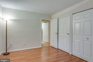 11232 Chestnut Grove Square, Unit 20 Reston, VA 20190 - Photo 22 of 40 a view of an empty room with wooden floor