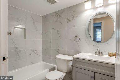 11232 Chestnut Grove Square, Unit 20 Reston, VA 20190 - Photo 23 of 40 a bathroom with a sink toilet and shower