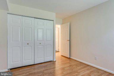 11232 Chestnut Grove Square, Unit 20 Reston, VA 20190 - Photo 26 of 40 a view of an empty room with wooden floor