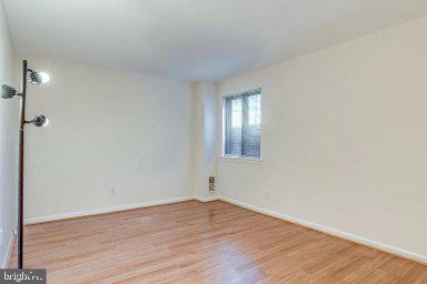 11232 Chestnut Grove Square, Unit 20 Reston, VA 20190 - Photo 27 of 40 a view of empty room with wooden floor and fan