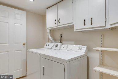 11232 Chestnut Grove Square, Unit 20 Reston, VA 20190 - Photo 31 of 40 a utility room with dryer and washer