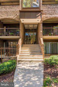 11232 Chestnut Grove Square, Unit 20 Reston, VA 20190 - Photo 34 of 40 a front view of a house with a porch
