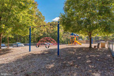 11232 Chestnut Grove Square, Unit 20 Reston, VA 20190 - Photo 6 of 40 a view of a park with swings and slides