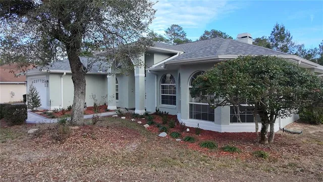 a backyard of a house with table and chairs