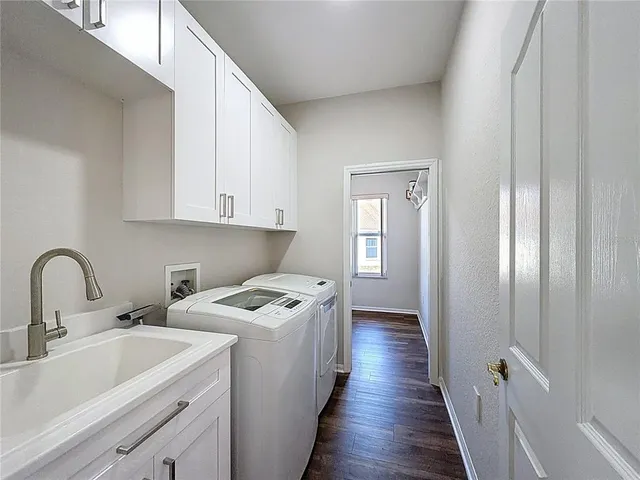 a room with sink a washer and dryer