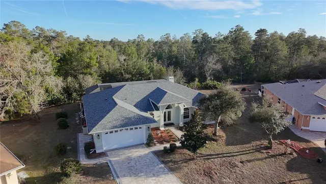 an aerial view of a house with yard