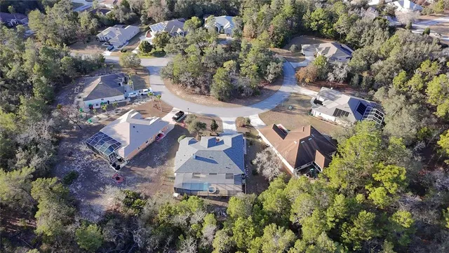 an aerial view of a house with yard