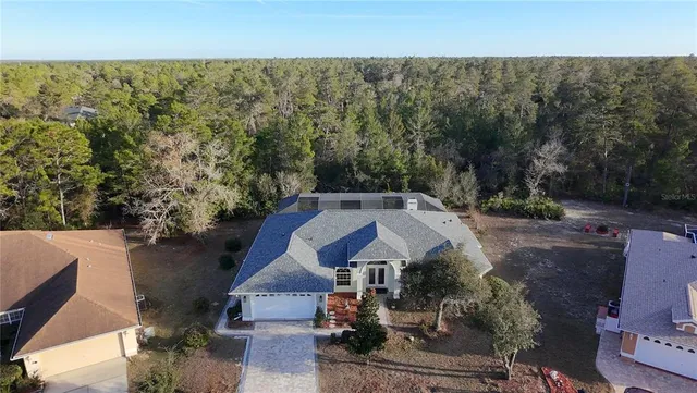 a view of a house with a yard and large tree