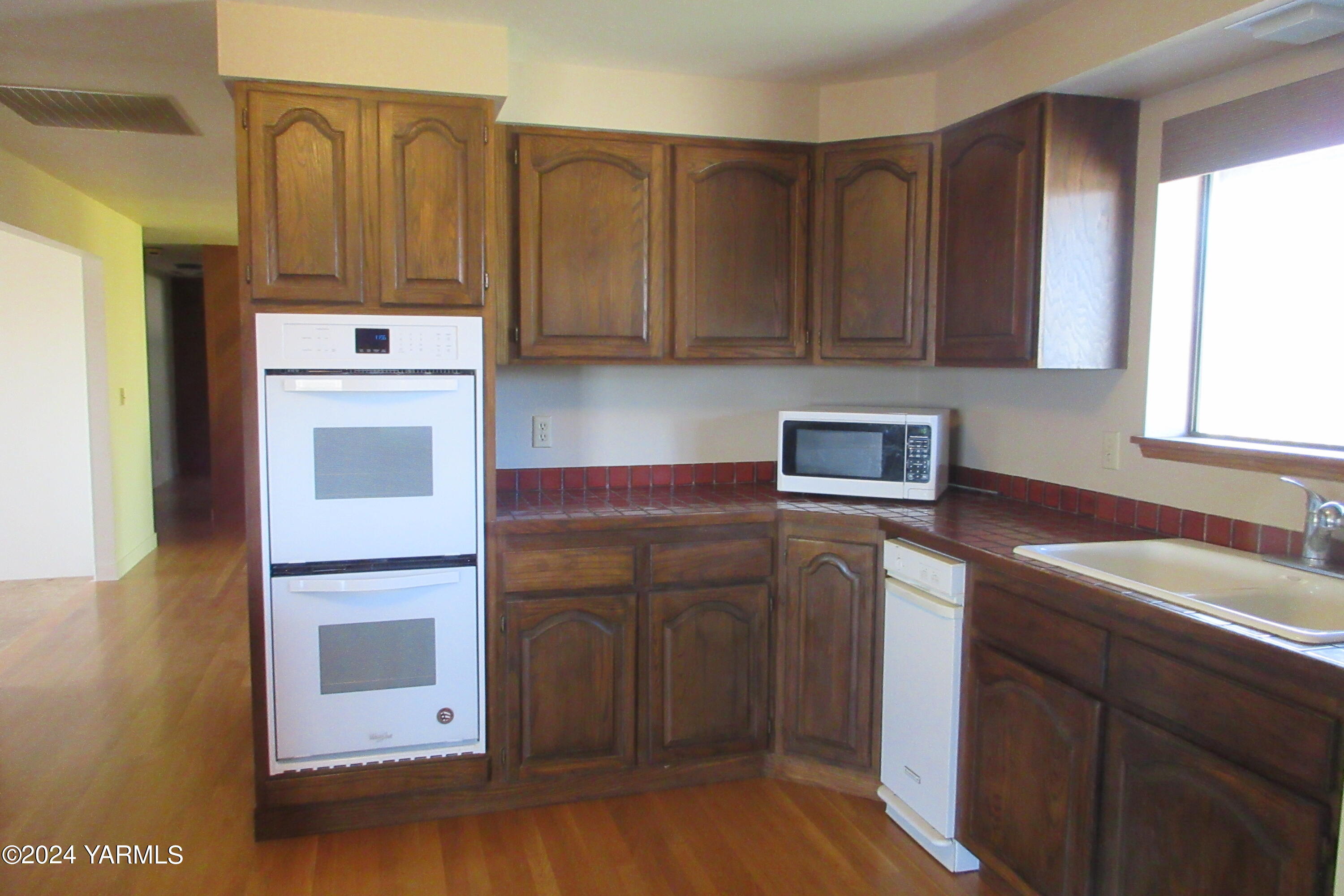 13510 Fisk Road Yakima, WA 98908 - Photo 15 of 61 a kitchen with a refrigerator sink and cabinets