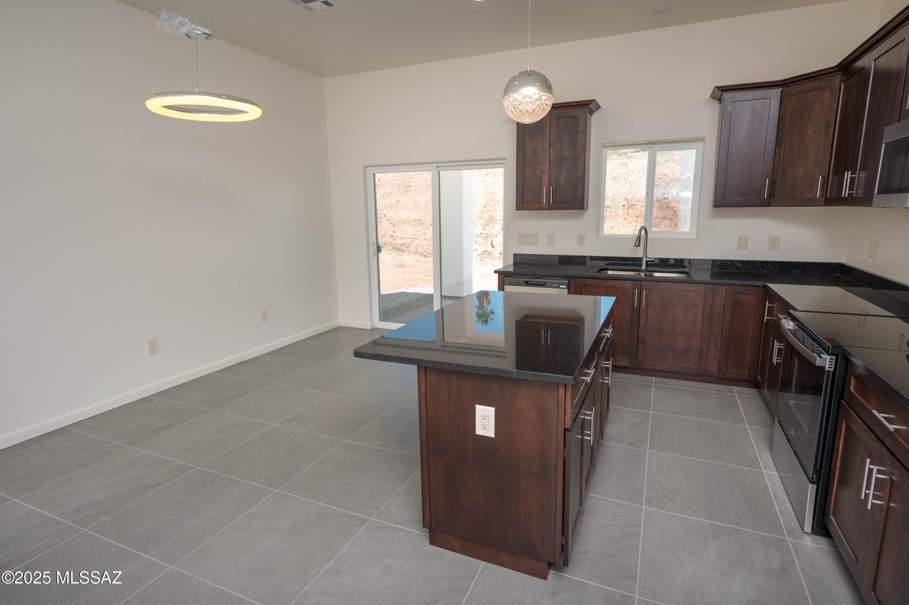 280 Donna Court Rio Rico, AZ 85648 - Photo 19 of 50 a kitchen with a sink a stove a microwave and cabinets