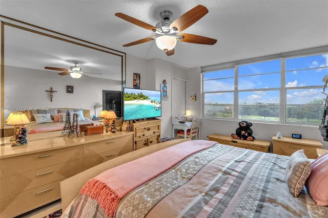 a bedroom with a large bed and a large window