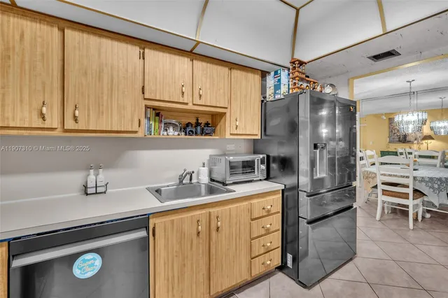 a kitchen with stainless steel appliances a refrigerator sink and cabinets