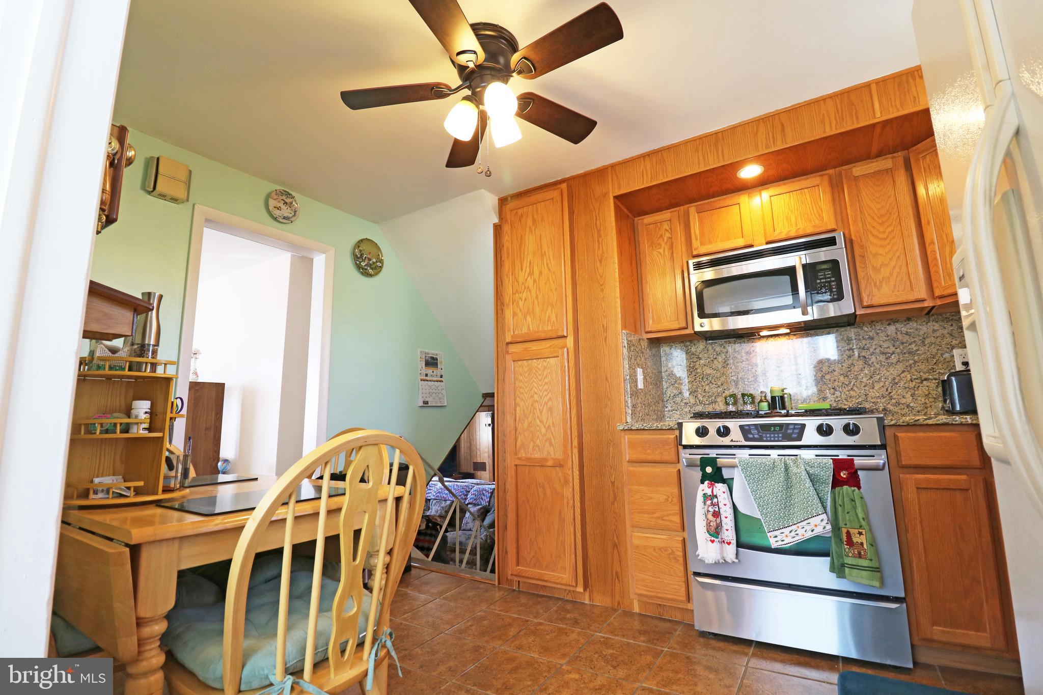 716 Cambridge Road Brookhaven, PA 19015 - Photo 11 of 42 a view of a kitchen with furniture and stainless steel appliances
