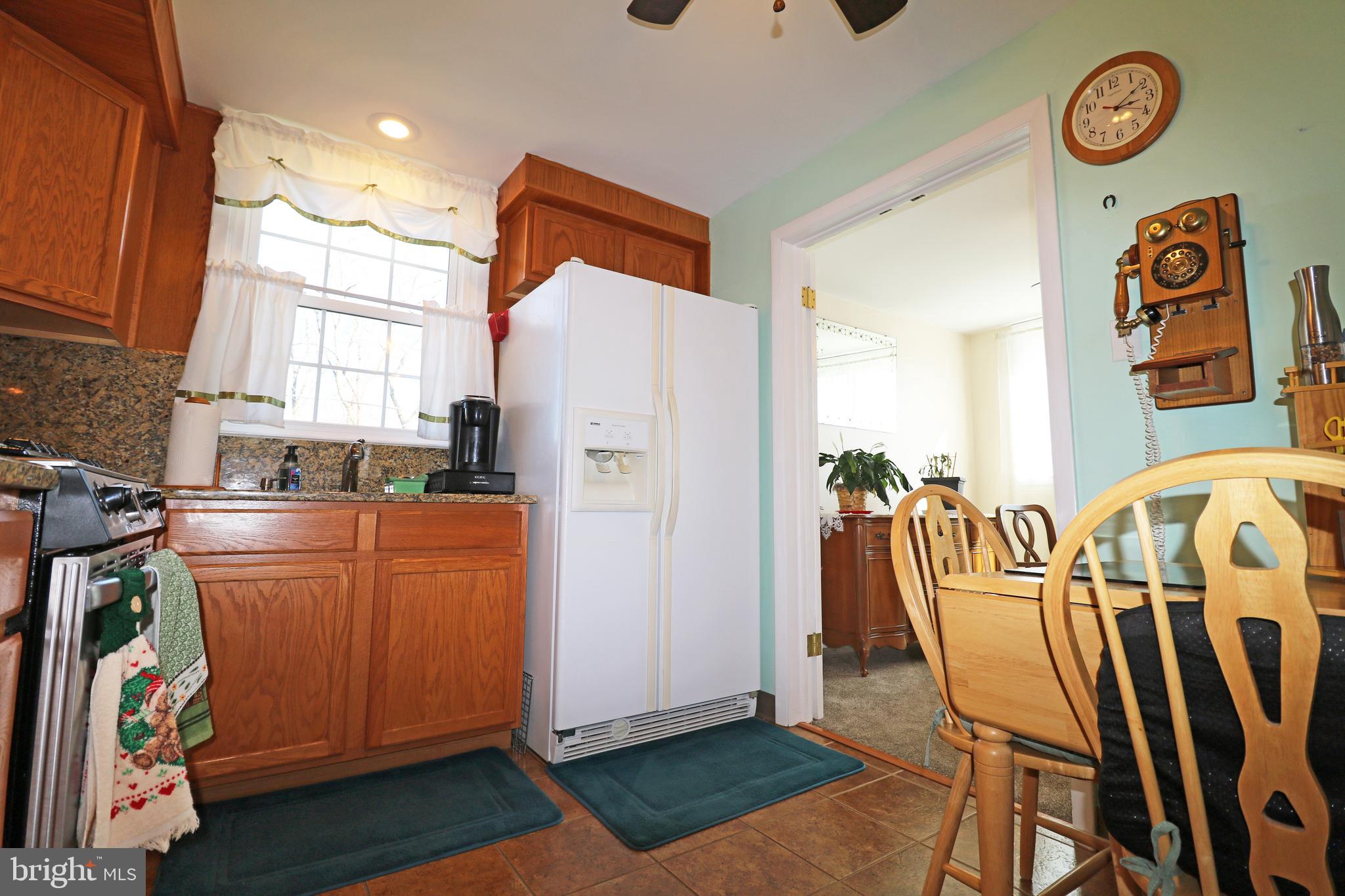 716 Cambridge Road Brookhaven, PA 19015 - Photo 12 of 42 a view of a kitchen with fridge and workspace