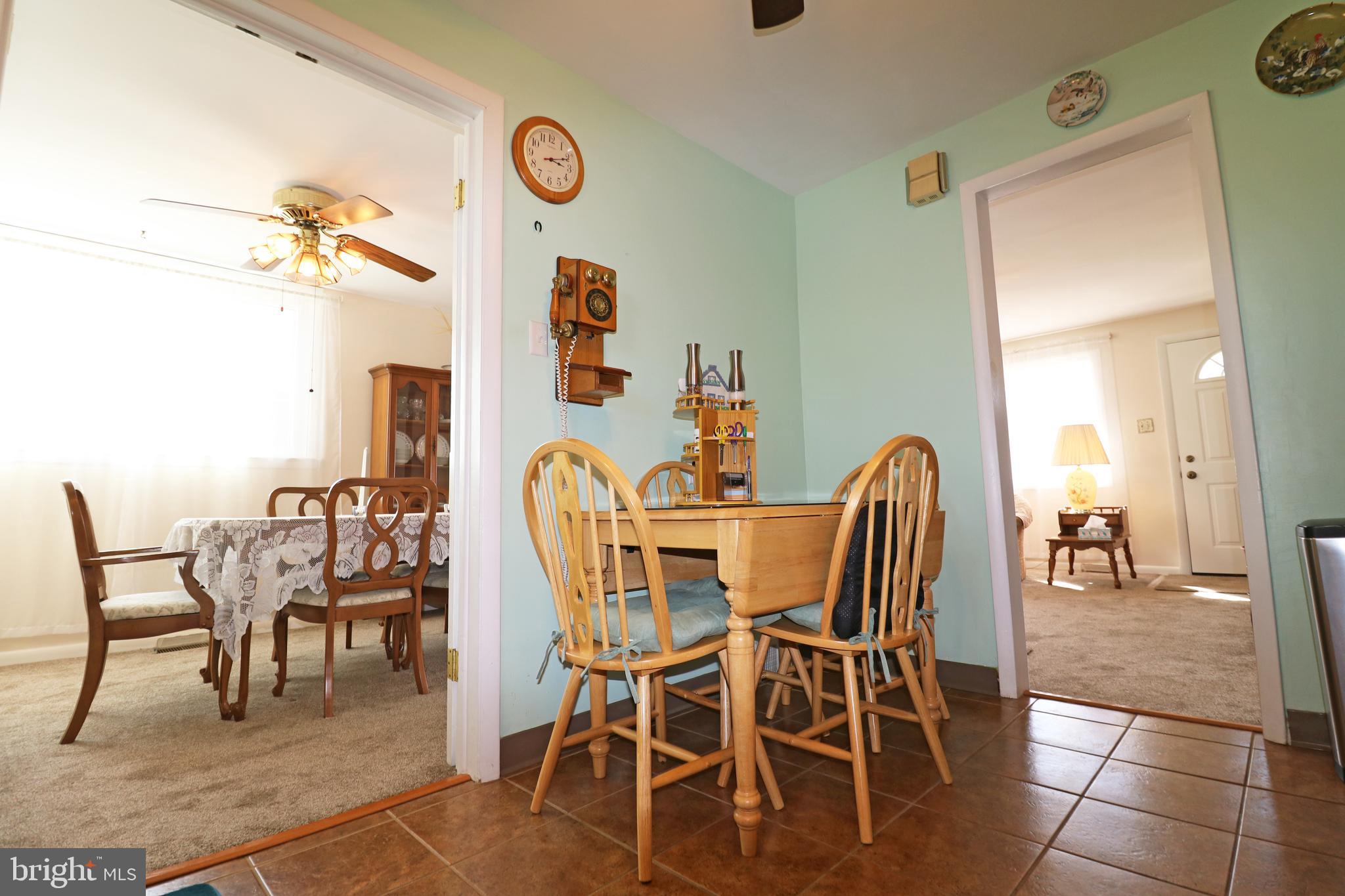 716 Cambridge Road Brookhaven, PA 19015 - Photo 15 of 42 a dining room with furniture and wooden floor