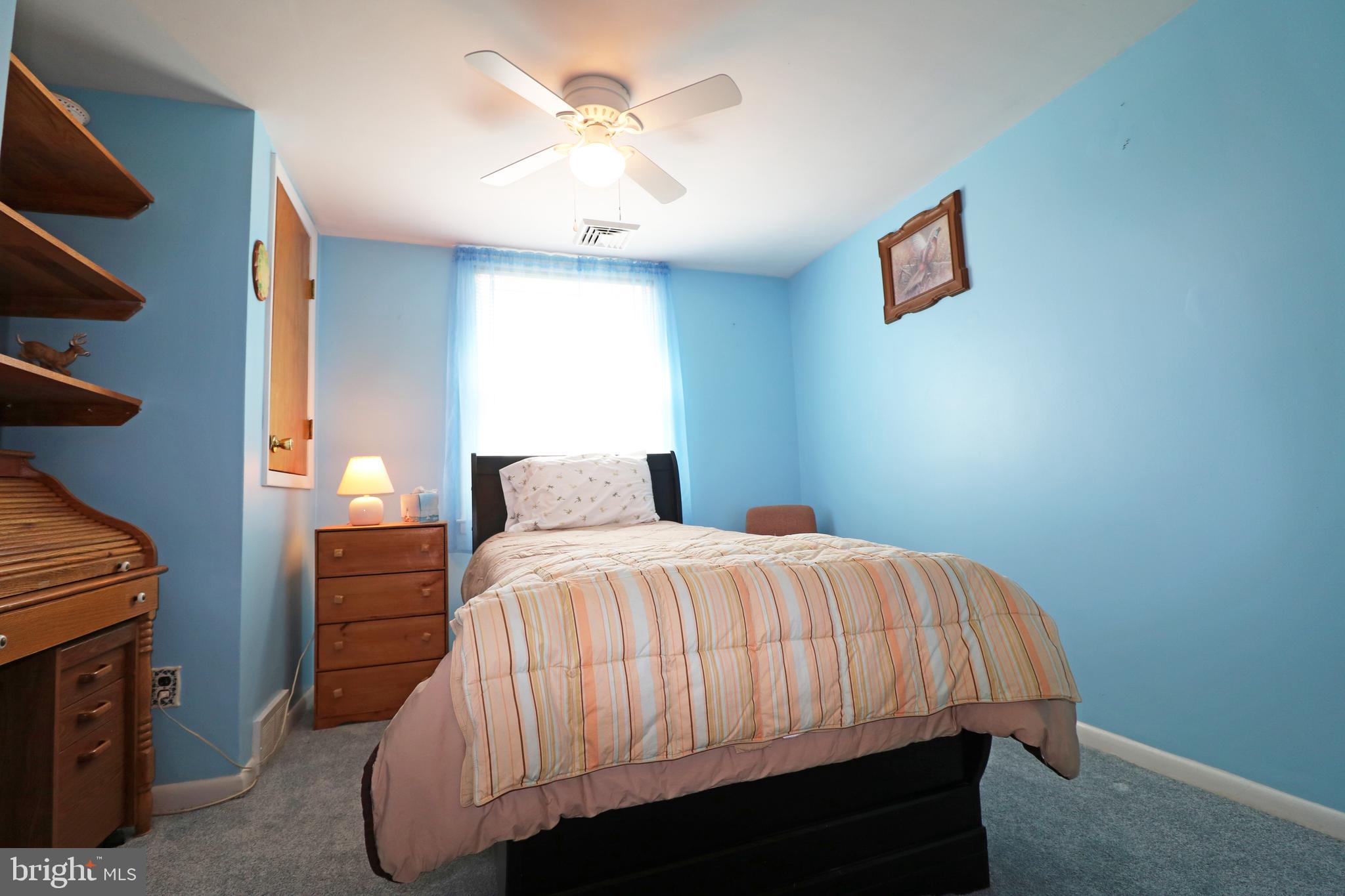 716 Cambridge Road Brookhaven, PA 19015 - Photo 16 of 42 a bedroom with a bed and a chandelier