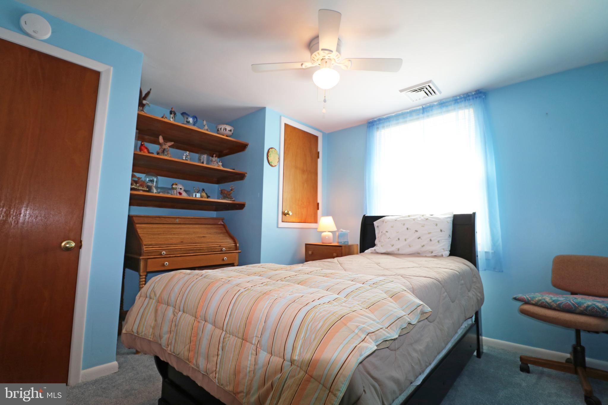 716 Cambridge Road Brookhaven, PA 19015 - Photo 17 of 42 a bedroom with a bed and a chandelier